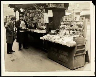 Blind news dealer, John Comuni, at his stand at 3rd Avenue and 18th Street, New York, 1926
